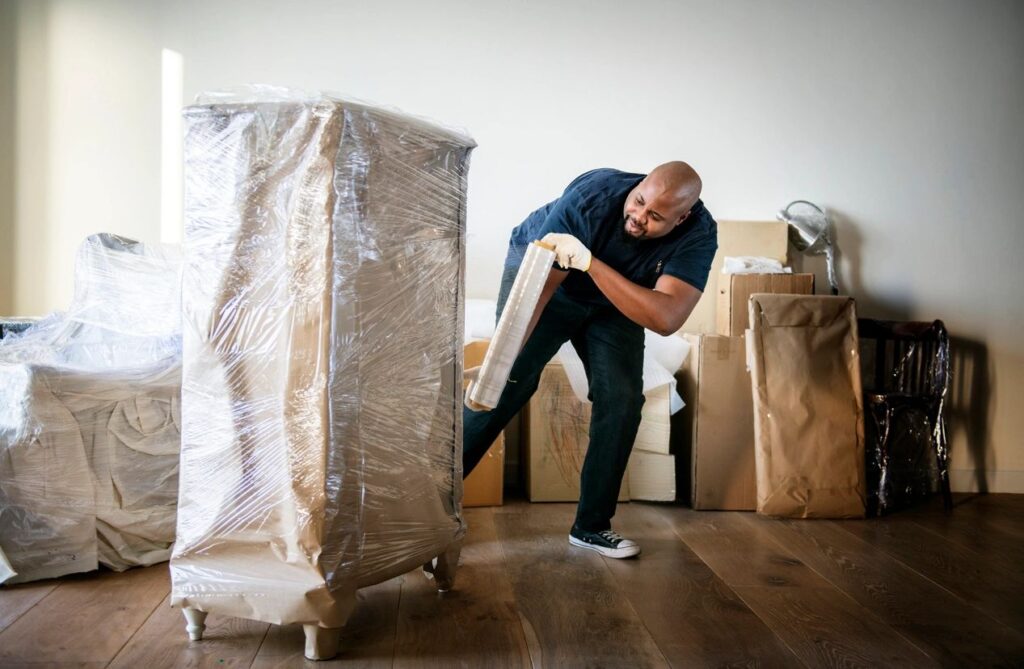 qtq80-ZFJRgG a man moving boxes with a trolly